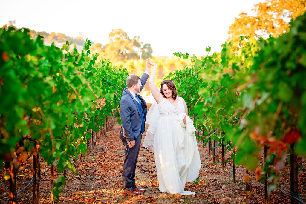 Bride and groom dancing in the vineyards
