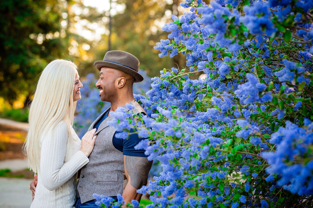 couple standing in a garden of blue flowers at UC Davis Arboretum