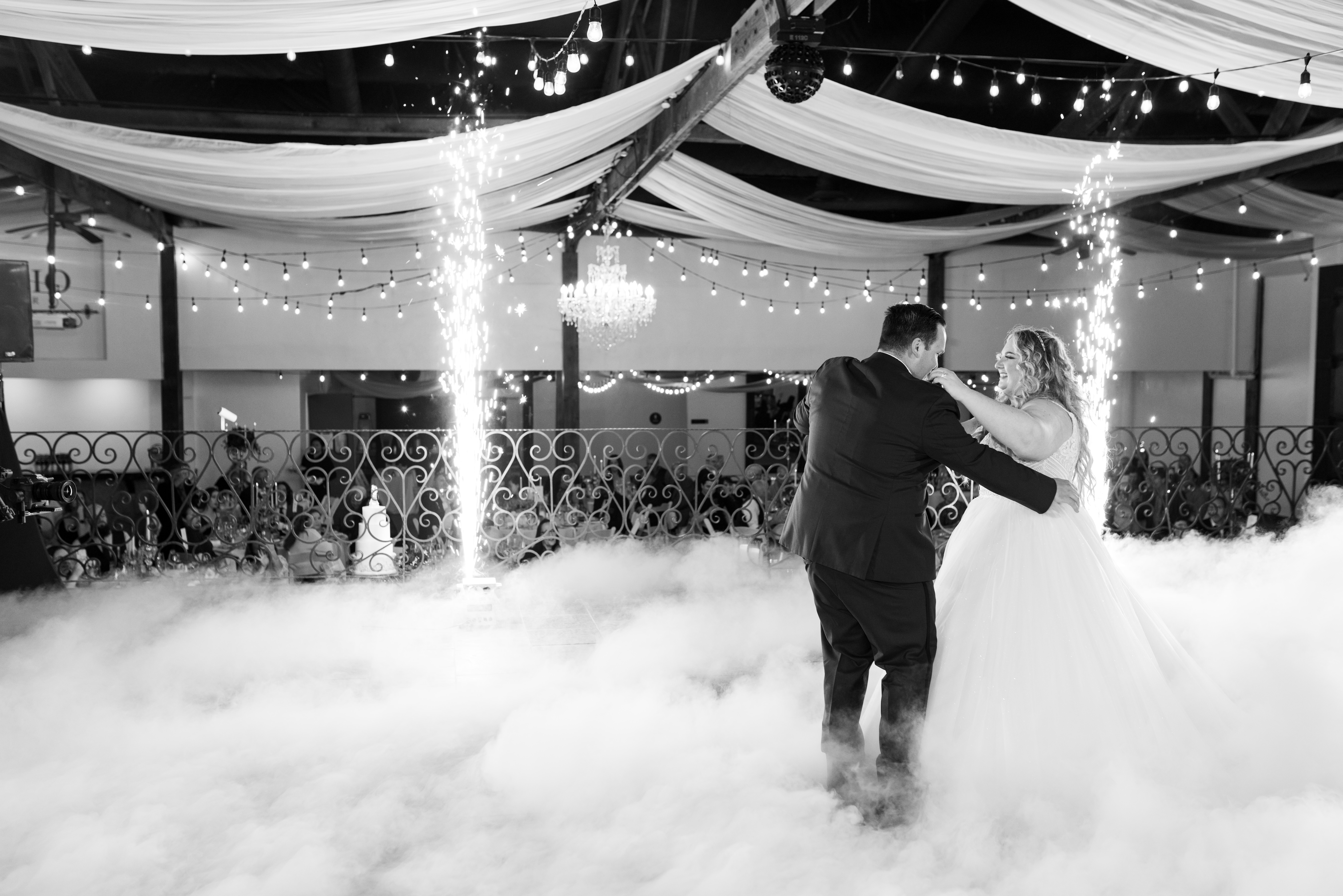 Bride and groom dancing on clouds with fireworks at Viaggio winery wedding venue in sacramento