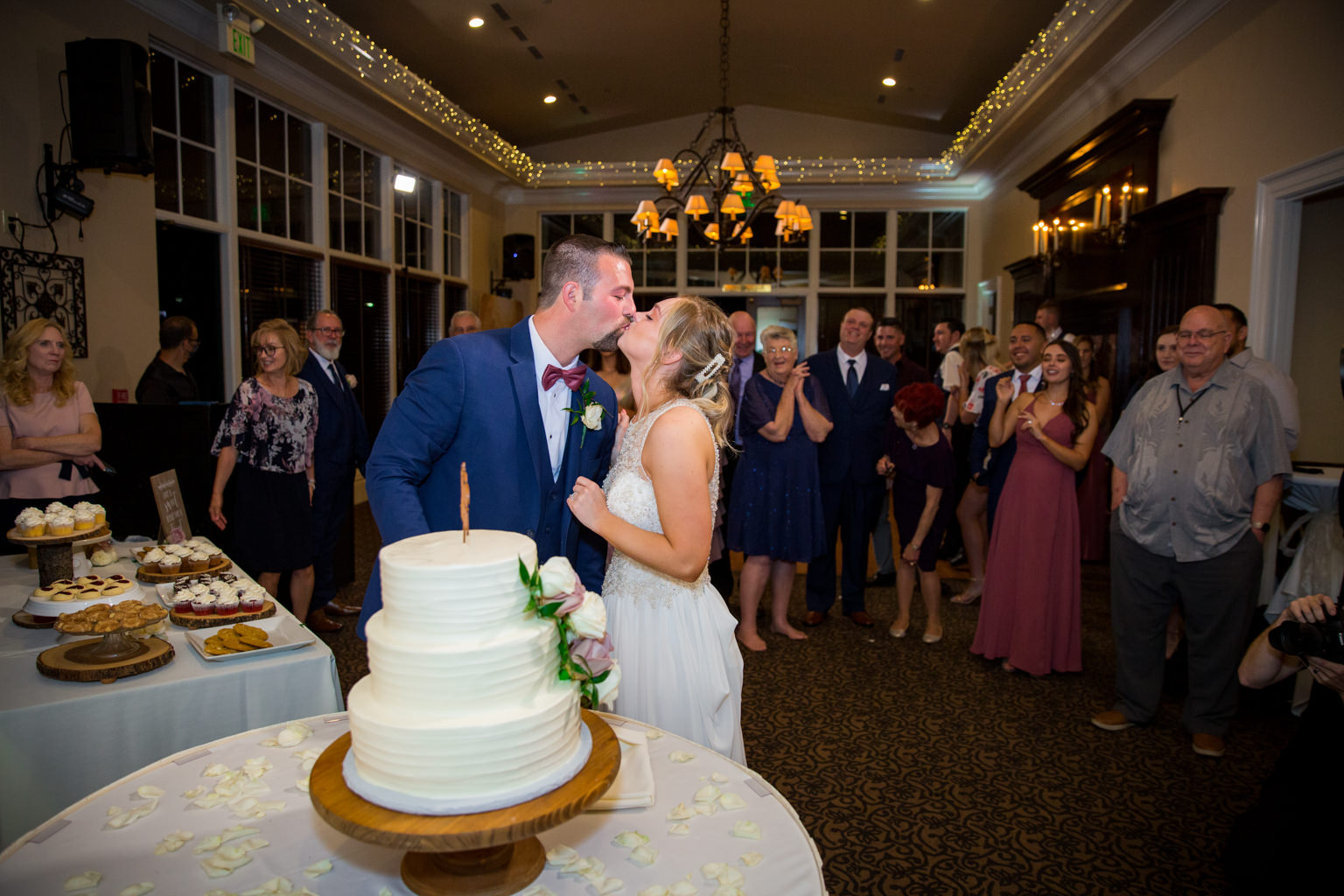 bride and groom cutting cake in the Eagle Ridge Weddings ballroom