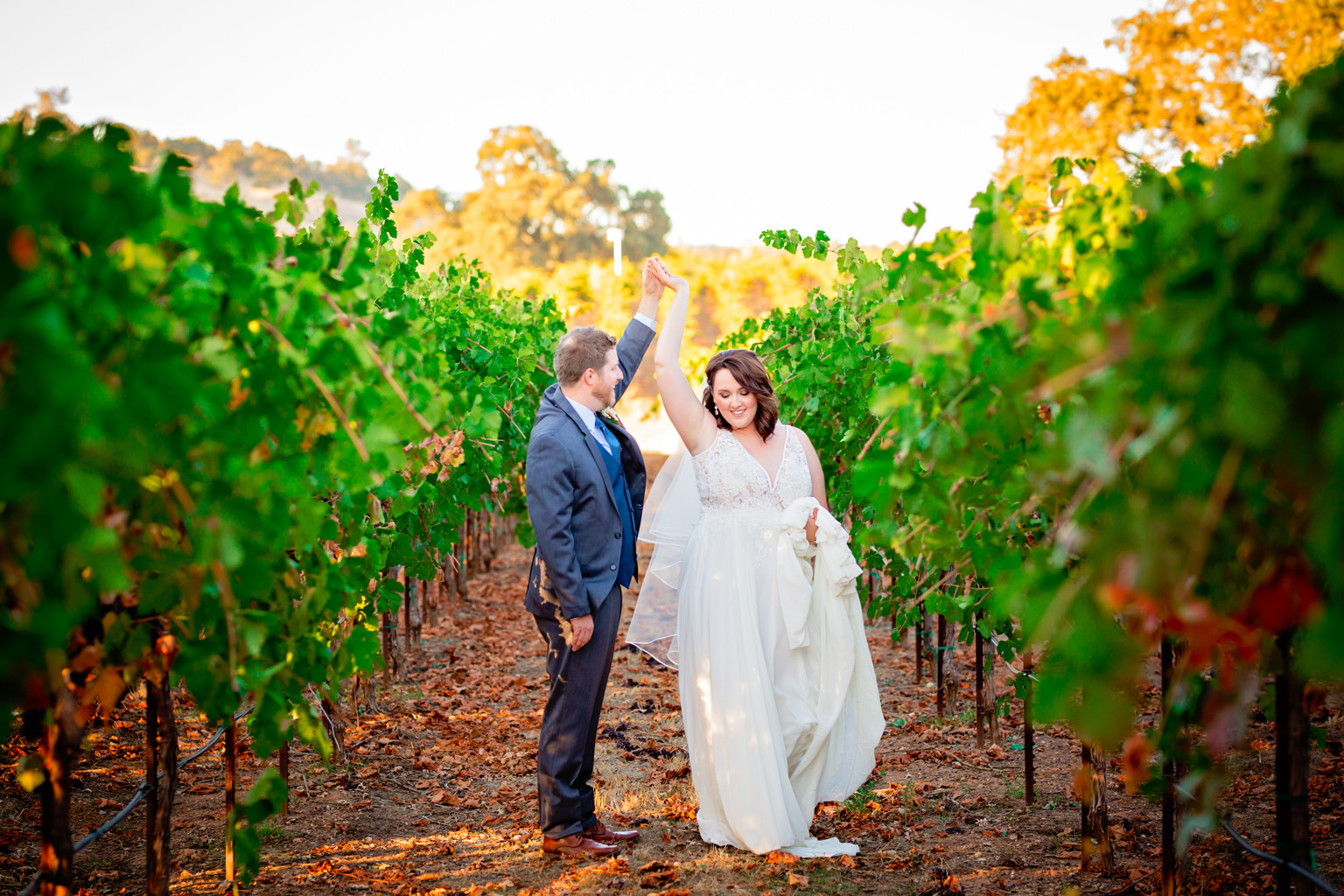 groom spinning the bride at the beautiful vineyards at rancho victoria