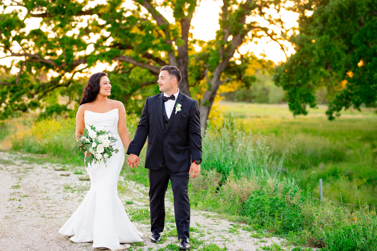 Bride and groom taking sunset photos on their wedding day at the barn at twin ponds with sacramento wedding photographer ashley teasley